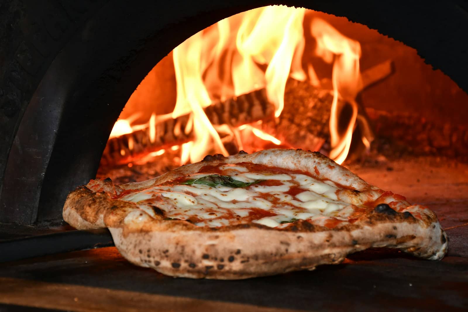 Neapolitan pizza coming out of the wood-fired oven — NapoliForno, private pizza chef Costa Blanca